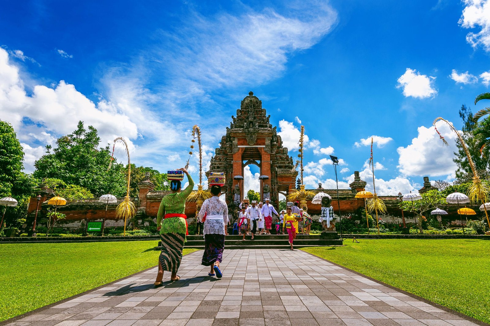 BALI, INDONESIA - APIRL 26, 2017 : Balinese people in traditional clothes during religious ceremony at Pura Taman Ayun Temple, Bali in Indonesia.
